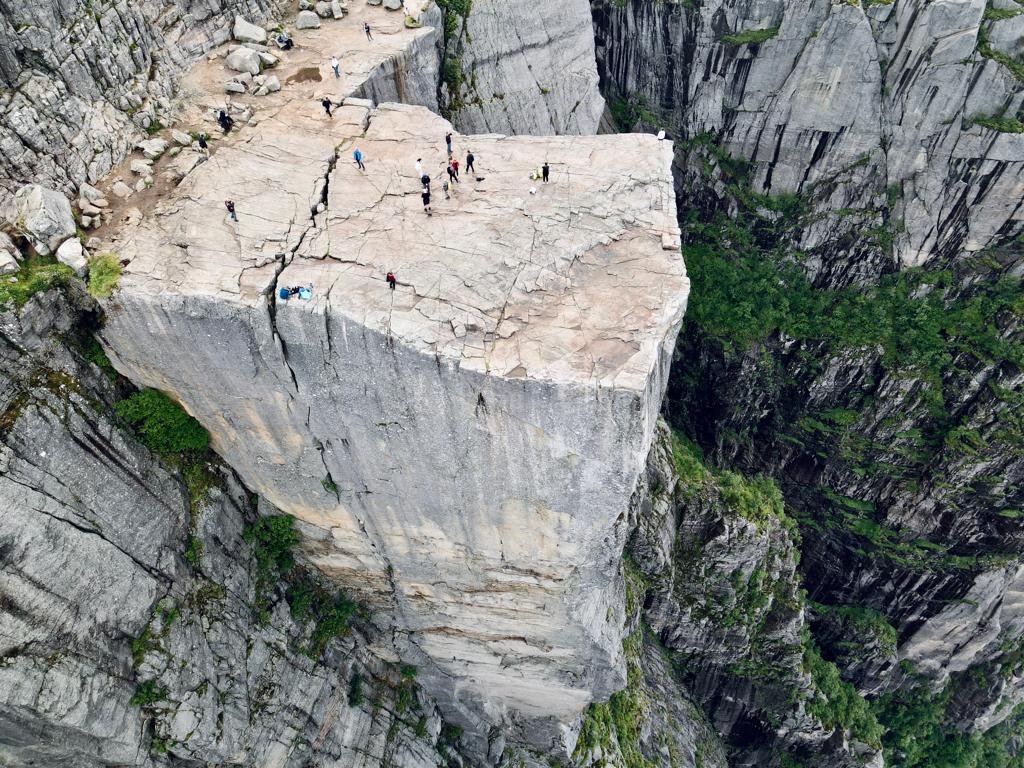 Motorcyclist posing on the famous Preikestolen rock - An iconic place in Norway.