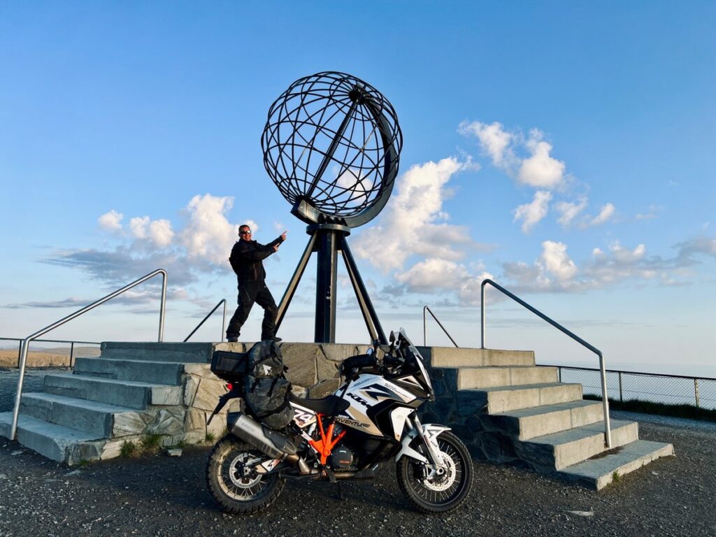 Motorcyclist with KTM Adventure at the North Cape Globe - A dream destination for motorcycle tours in Norway.